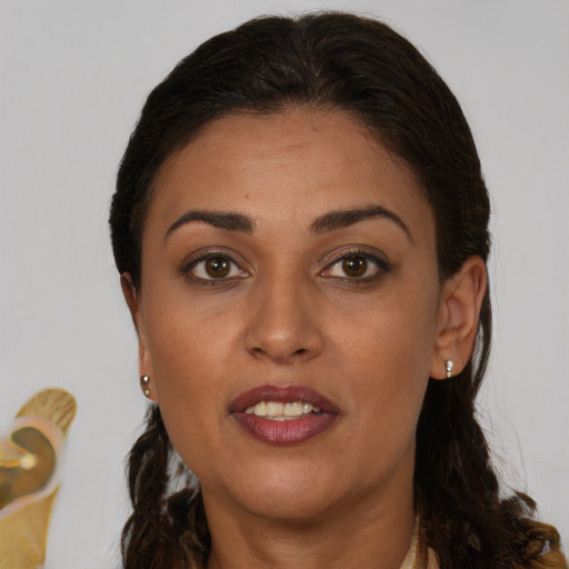 Joyful latino adult female with long  brown hair and brown eyes
