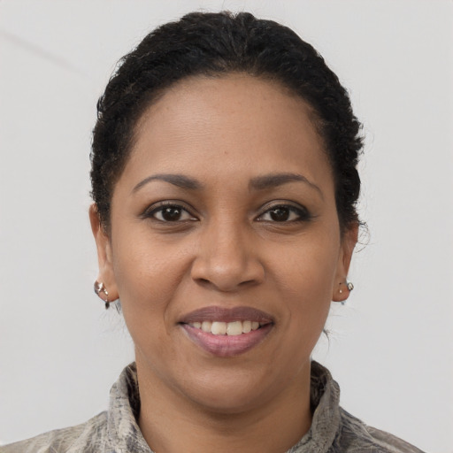Joyful latino young-adult female with short  brown hair and brown eyes