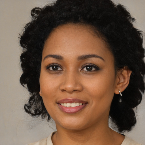Joyful black young-adult female with medium  black hair and brown eyes
