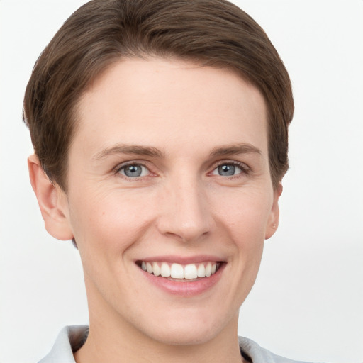 Joyful white young-adult female with short  brown hair and grey eyes