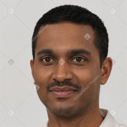 Joyful black young-adult male with short  black hair and brown eyes