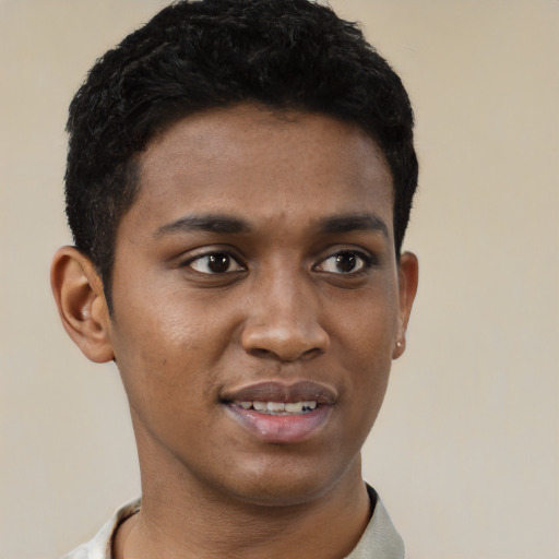 Joyful black young-adult male with short  black hair and brown eyes