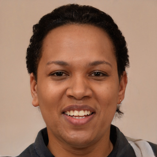 Joyful latino adult female with short  brown hair and brown eyes