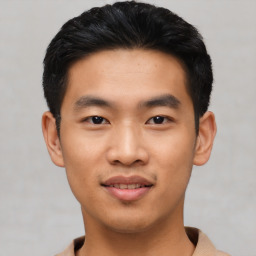 Joyful asian young-adult male with short  black hair and brown eyes