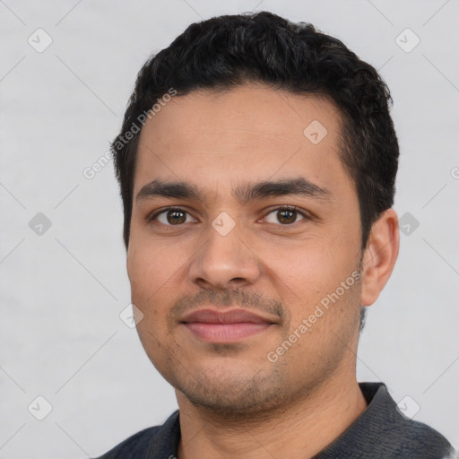 Joyful white young-adult male with short  black hair and brown eyes
