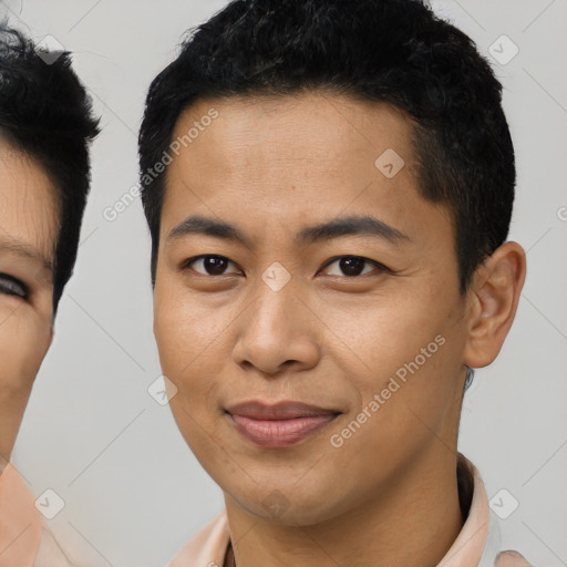 Joyful asian young-adult male with short  brown hair and brown eyes