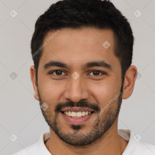 Joyful latino young-adult male with short  black hair and brown eyes