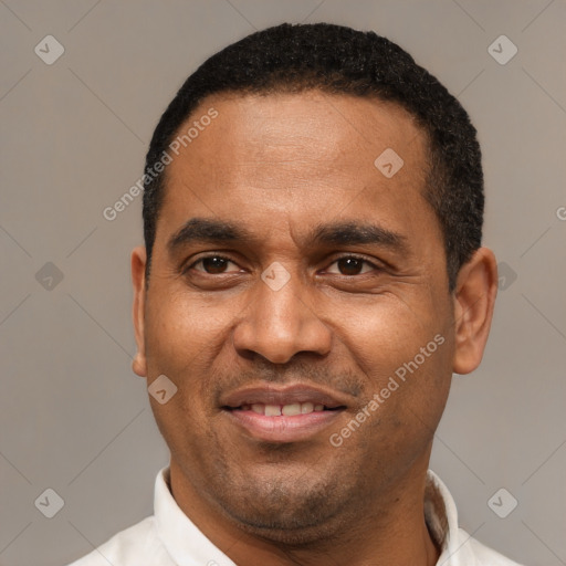 Joyful latino adult male with short  black hair and brown eyes