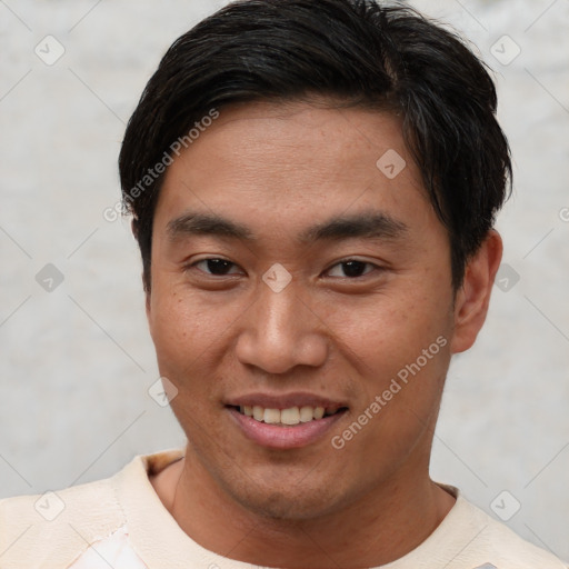 Joyful asian young-adult male with short  brown hair and brown eyes