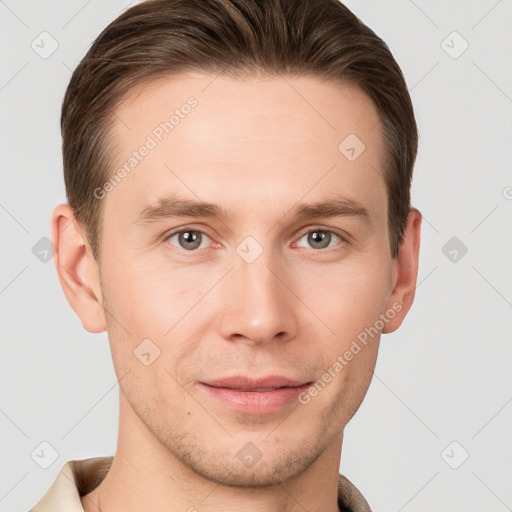 Joyful white young-adult male with short  brown hair and grey eyes