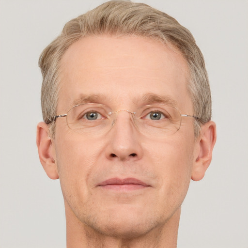 Joyful white adult male with short  brown hair and grey eyes