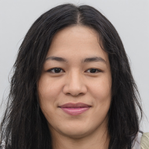 Joyful asian young-adult female with long  brown hair and brown eyes