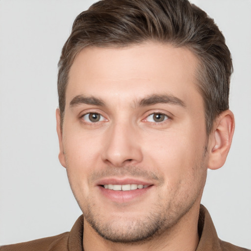 Joyful white young-adult male with short  brown hair and brown eyes