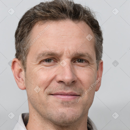 Joyful white adult male with short  brown hair and grey eyes