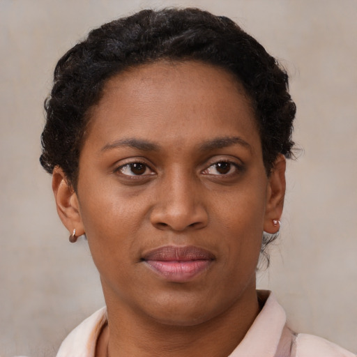 Joyful black young-adult female with short  brown hair and brown eyes