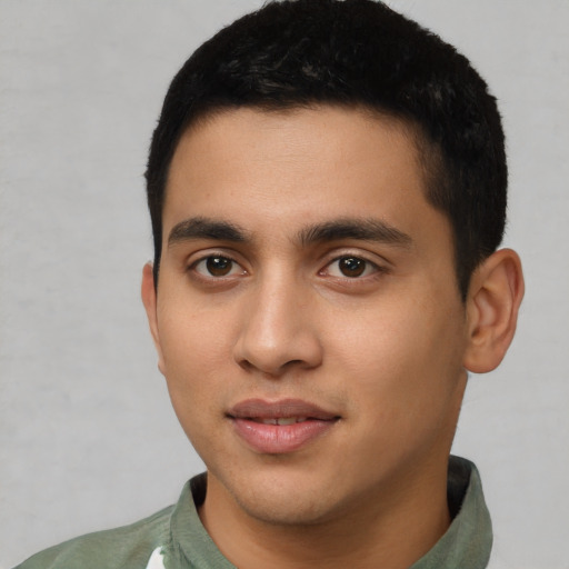 Joyful latino young-adult male with short  black hair and brown eyes