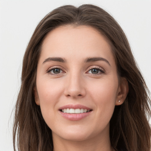 Joyful white young-adult female with long  brown hair and grey eyes