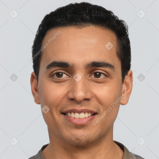 Joyful latino young-adult male with short  black hair and brown eyes