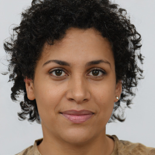 Joyful black young-adult female with short  brown hair and brown eyes