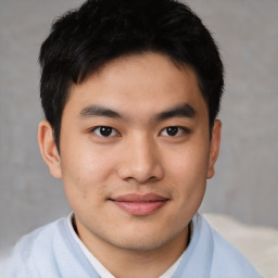 Joyful asian young-adult male with short  brown hair and brown eyes