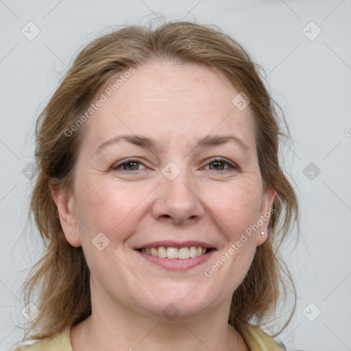 Joyful white adult female with medium  brown hair and blue eyes