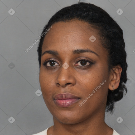 Joyful black young-adult female with short  black hair and brown eyes