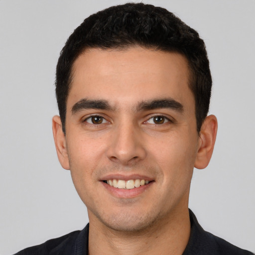 Joyful white young-adult male with short  black hair and brown eyes