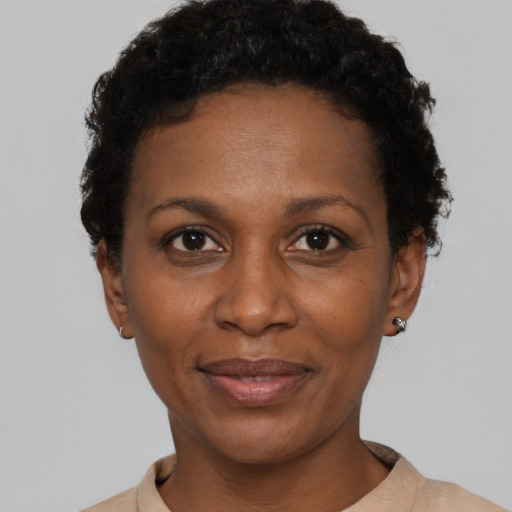 Joyful black adult female with short  black hair and brown eyes