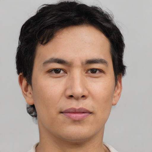 Joyful asian young-adult male with short  brown hair and brown eyes