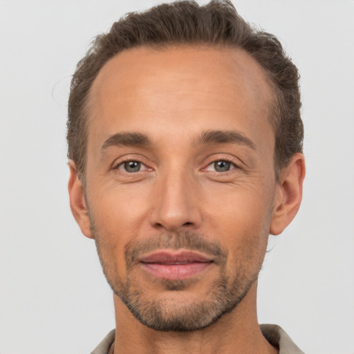 Joyful white adult male with short  brown hair and brown eyes