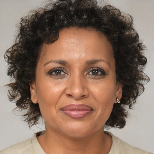 Joyful black adult female with medium  brown hair and brown eyes
