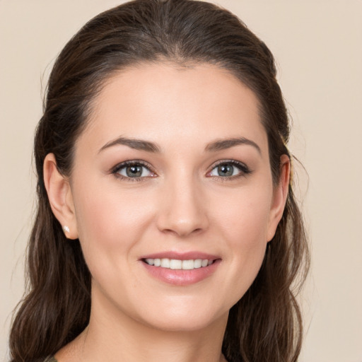 Joyful white young-adult female with medium  brown hair and brown eyes