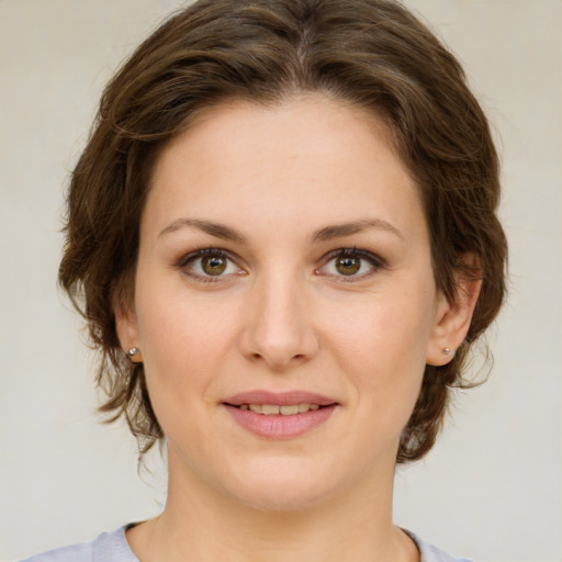 Joyful white young-adult female with medium  brown hair and green eyes