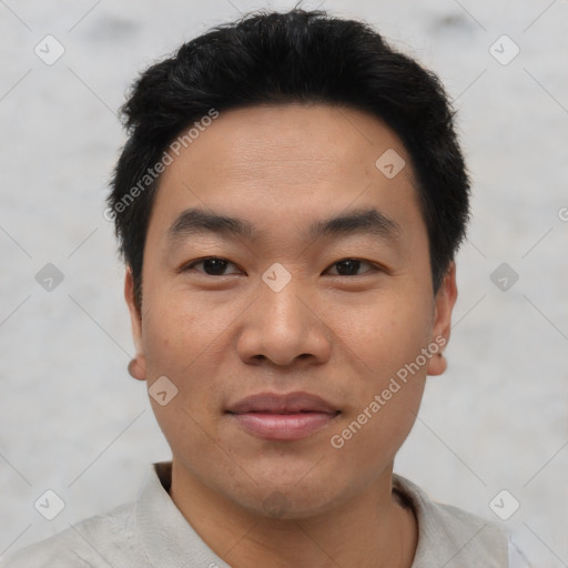 Joyful asian young-adult male with short  black hair and brown eyes