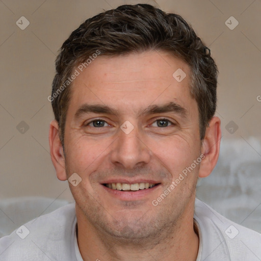 Joyful white adult male with short  brown hair and brown eyes