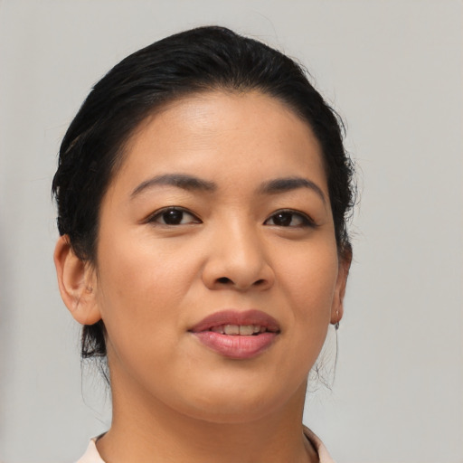Joyful asian young-adult female with medium  brown hair and brown eyes
