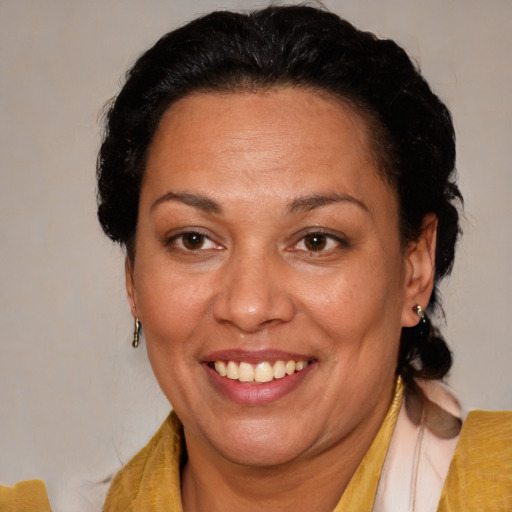 Joyful latino adult female with medium  brown hair and brown eyes