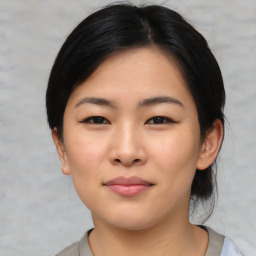 Joyful asian young-adult female with medium  black hair and brown eyes