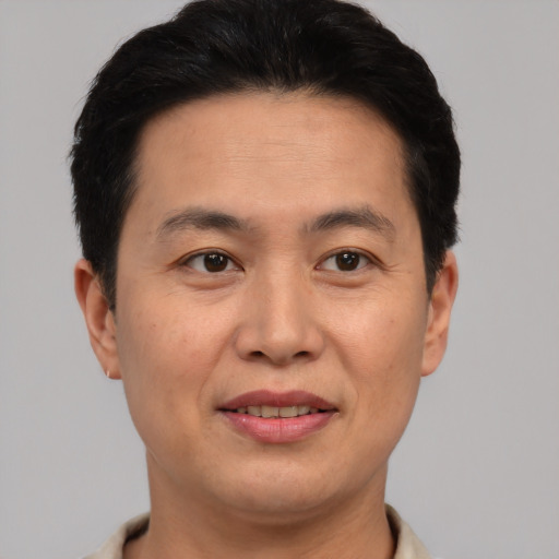 Joyful latino adult male with short  brown hair and brown eyes