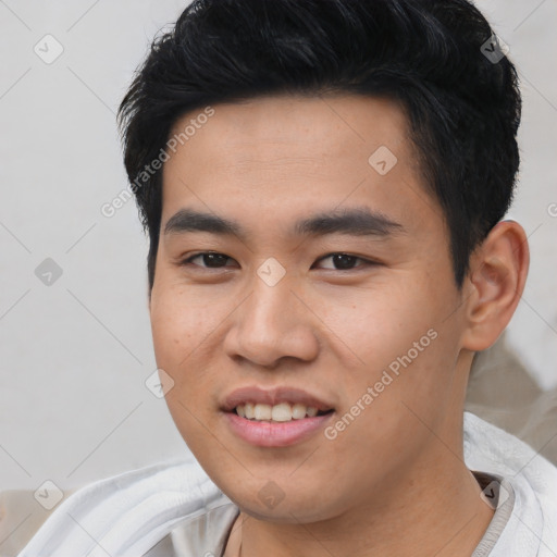 Joyful asian young-adult male with short  black hair and brown eyes