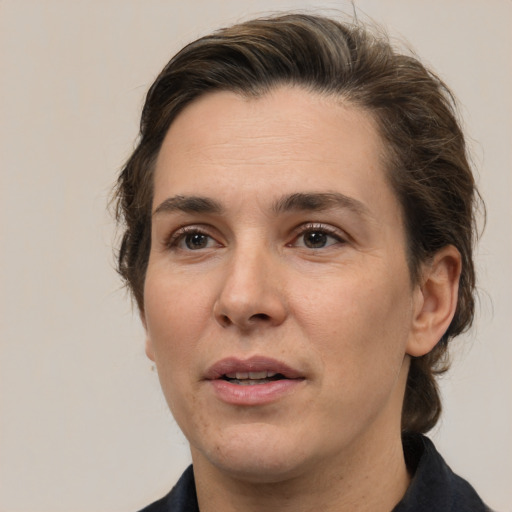 Joyful white adult female with medium  brown hair and brown eyes