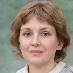 Joyful white young-adult female with medium  brown hair and blue eyes