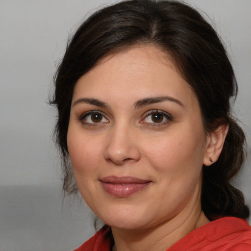 Joyful white young-adult female with medium  brown hair and brown eyes