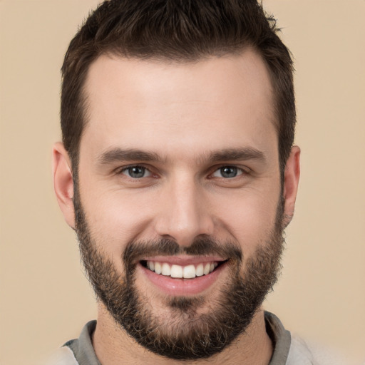 Joyful white young-adult male with short  brown hair and brown eyes