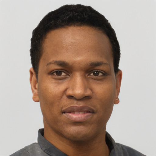 Joyful black young-adult male with short  black hair and brown eyes