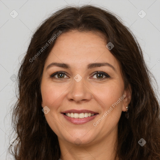 Joyful white adult female with long  brown hair and brown eyes