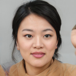 Joyful asian young-adult female with medium  black hair and brown eyes