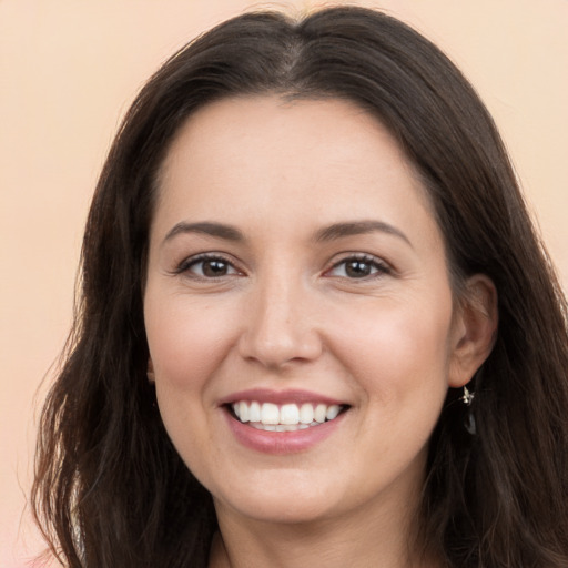 Joyful white young-adult female with long  brown hair and brown eyes