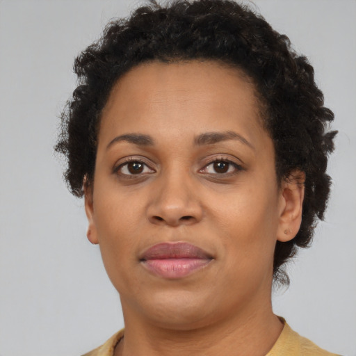 Joyful black adult female with short  brown hair and brown eyes