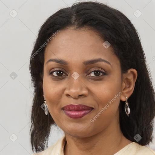 Joyful black adult female with medium  brown hair and brown eyes